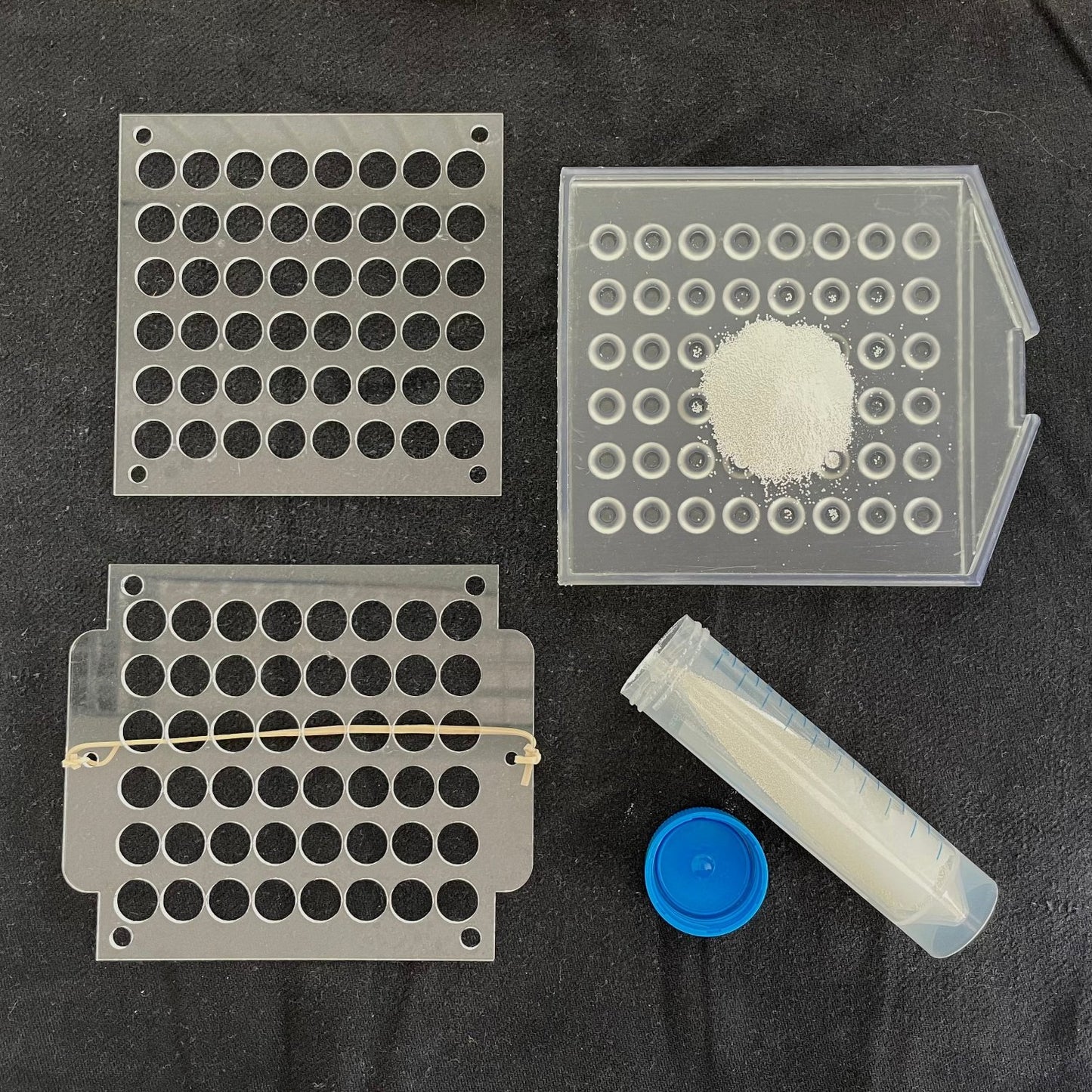 Powder dispenser for 48 tubes - alignment plates on the left and the measurement plate on he top right